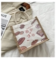 Detail der Canvas-Einkaufstasche mit Brotillustrationen und gewebter Jute-Textur - Brot