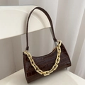 Dark brown crocodile embossed baguette bag with golden chain on a white chair - Dark Brown