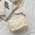 Chic beige PU leather baguette underarm bag with adjustable strap and front pocket - Off White