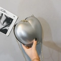 Silver heart-shaped chain crossbody bag with metallic finish and gold strap for women - Silver