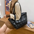 Large black quilted puffer tote bag with glossy finish and durable fabric straps - Black
