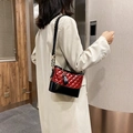 Red and black quilted shoulder bag with chain strap shown on a model's shoulder - Small / Burgundy