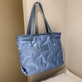 Quilted light blue puffer tote bag with long shoulder straps and shiny nylon texture - Blue