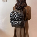 Chic black quilted down backpack with silver zippers and large capacity for winter commute - Black