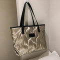 Champagne gold quilted tote bag with black shoulder strap and fashion label design - Champagne