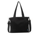 Minimalist black canvas tote bag with adjustable shoulder strap and blue logo patch - Black