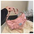 Pink patent leather crossbody bag with chic bow detail and elegant pleated design - Pink