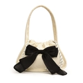 Chic off-white corduroy handbag with a large black bow and drawstring closure - White