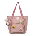 Roze nylon schoudertas met kleurrijke sterren en een wit pluche hanger sieraad - Roze