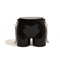 Unique torso-shaped black crossbody bag with gold snake chain strap on white background - Black