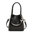 Glossy black PU leather bucket bag for women with a silver balloon dog pendant accessory - Black