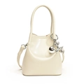 Minimalist beige PU leather bucket bag with silver balloon dog charm and top handle - White