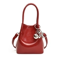 Glossy red PU leather bucket handbag with silver balloon dog charm and adjustable strap - Red