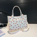 White corduroy tote bag with strawberry print and double outer pockets for daily use - White