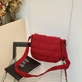 Deep red quilted crossbody bag with adjustable fabric strap and textured stitching - Red