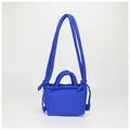 Detailed macro shot of electric blue quilted puffer bag with drawstring and knot strap - Sapphire Blue