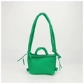 Detail view of puffer nylon bag with quilted texture and drawstring knots in bright green - Green