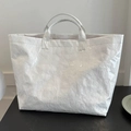 Minimalist white tote bag in Tyvek fabric with embossed lettering and crinkle texture - White