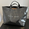 Minimalist black glossy tote bag with TOTE BAG print and stylish top handles - Black
