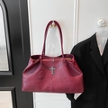 Detail of vintage dark red tote bag with metal cross pendant and fine leather texture - Red