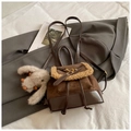Close-up of brown suede backpack with faux fur trim and cute white plush rabbit charm - Brown with Pendant
