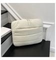Detail of quilted off-white laptop sleeve with front zipper pocket and nylon texture - White