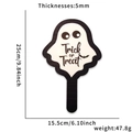 Macro view of a 5mm thick wooden Halloween ghost sign with Trick or Treat text - Ghost Style / Handheld Sign