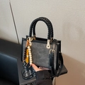Gray crossbody bag with black braided rope handles and cartoon embossed texture - Black With Pendant