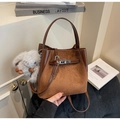 Detailed view of brown suede bucket bag with silver metal clasp and faux fur charm - With Pendant / Brown