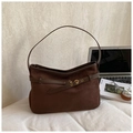 Detail of dark brown suede tote bag with metal eyelet belt and leather texture - Brown