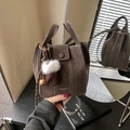 Chic dark brown bucket bag with contrast stitching and festive plush pendant accessory - Coffee with Pendant