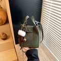 Dark green suede bucket bag with top handles, crossbody strap and plush ball charm - Green with Pendant