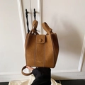 Brown faux suede bucket bag with gold lettering and top handles in minimalist style - Brown No Pendant