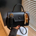 Elegant black minimalist crossbody bag with multi-color wooden bead tassel detail - Black
