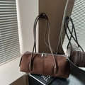 Minimalist dark brown cylindrical shoulder bag in textured matte leather finish - Brown
