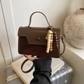 Brown vintage leather crossbody bag with top handle and wooden bead pendant detail - Brown