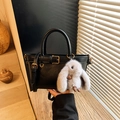 Classic black leather handbag with golden buckle and grey plush rabbit pendant accessory - Black With Pendant