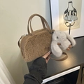 Detailed macro view of brown faux shearling box bag with plush texture and cute bunny charm - Brown with Pendant