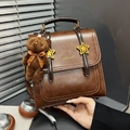 Vintage brown PU leather backpack for women featuring star buckle and plush bear charm - Brown with Pendant