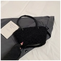 Minimalist black plush shoulder bag with leather handles and metallic ring buckles - Black