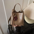Brown crocodile embossed bucket bag with long strap and a bear charm accessory - Khaki with Pendant
