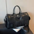 Black travel bag with pleated leather texture, dual handles and adjustable shoulder strap - Black