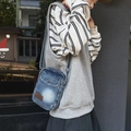Vertical blue denim crossbody bag featuring vintage washed texture and brown logo patch - Light Blue