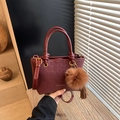 Deep red retro leather bucket bag with leopard texture and plush charm accessory - Style With Charm / Red