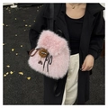 Pink faux fur backpack detail showing soft texture and brown doll charm on dark coat - Pink With Charm