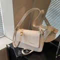 Creamy white crossbody bag with woven texture lid and elegant gold-tone hardware - Off White