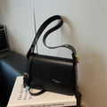 Fashionable black square shoulder bag featuring woven texture flap and golden hardware - Black