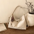Detailed view of beige faux leather tote bag with metal buckle and cute bear pendant - With Charm / White