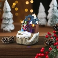 Caja de música navideña de resina luminosa con Papá Noel sobre una casa nevada - Estilo Techo Azul
