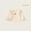 Maglietta bambina maniche lunghe in cotone crema con ricamo di ciliegie e volant rossi - Albicocca / 73
